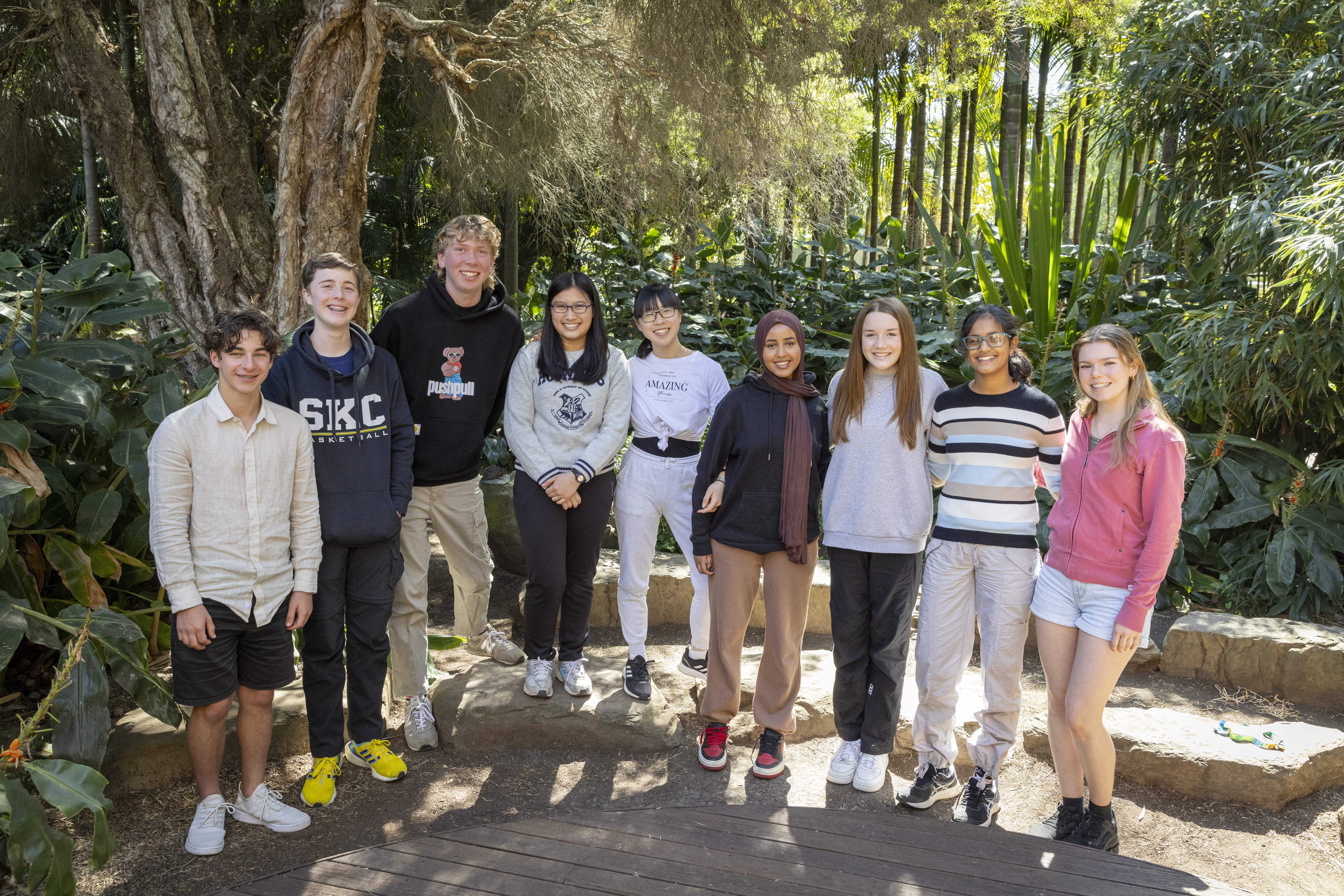 The nine then-active members of ZV's Youth Advisory Committee, rowed up in the Rainforest and smiling to the camera.